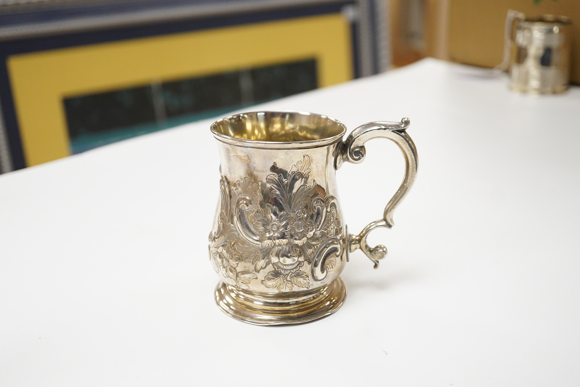 A George II silver baluster mug, by John Bayley, London, 1751, with later embossed decoration, height 95mm, 6.4oz.